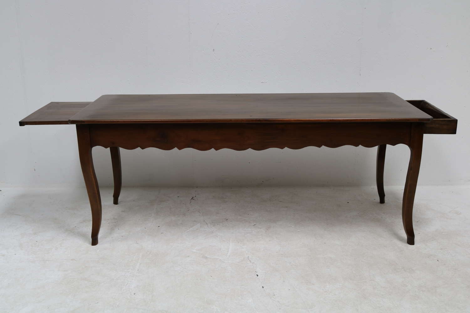 A French cherry wood cabriole leg dining table with breadslide ends