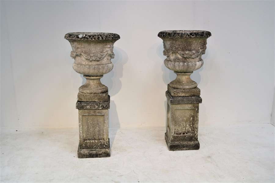 A large pair of marble di latte urns on stands
