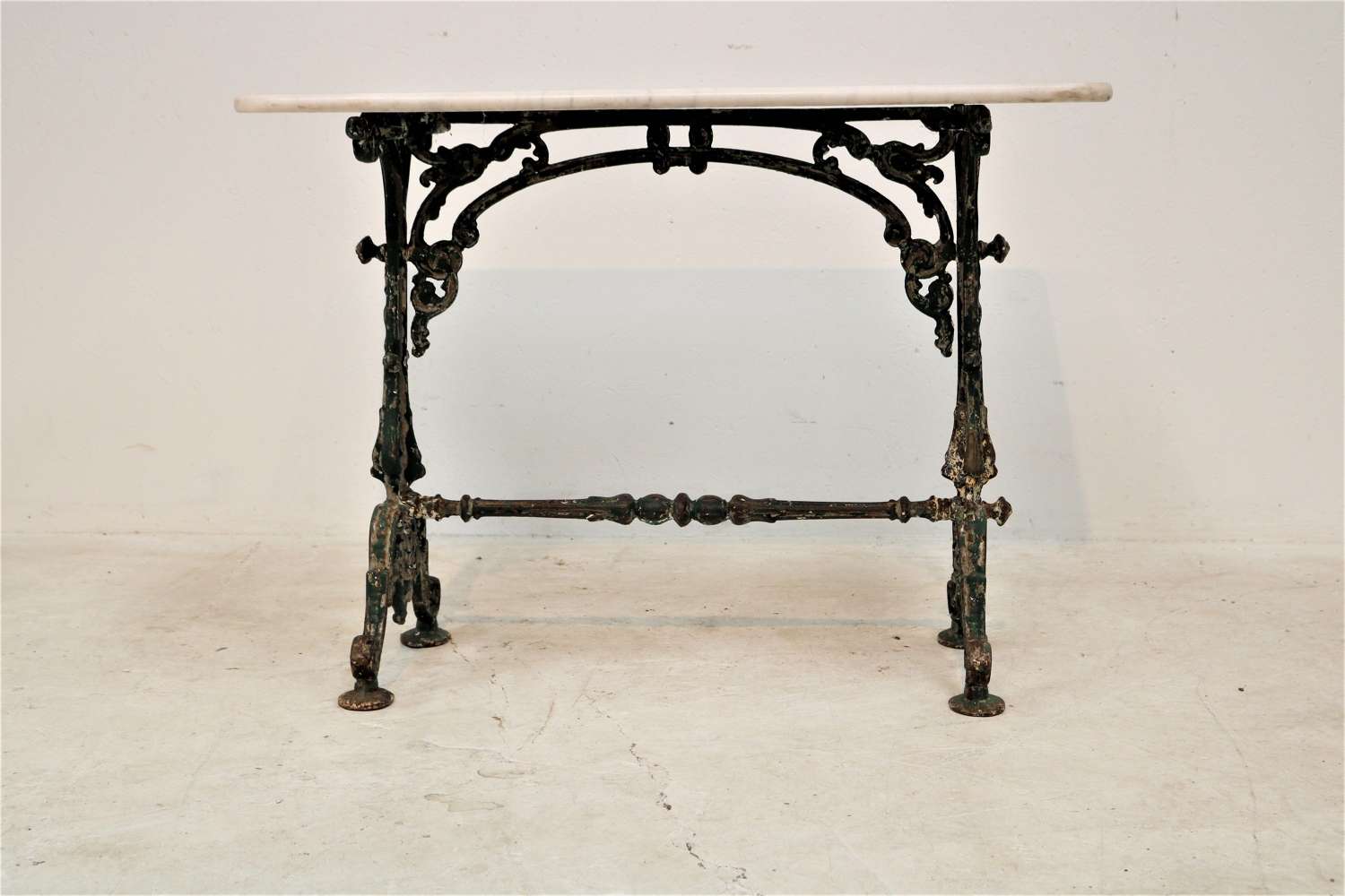 A 19th century cast iron and marble bistro table