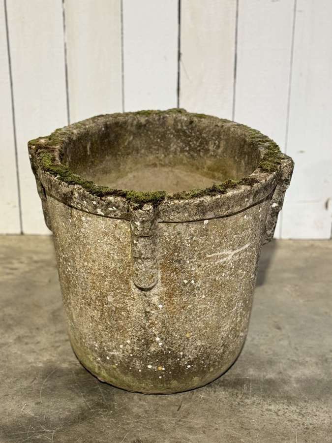 A large brutalist stone pot